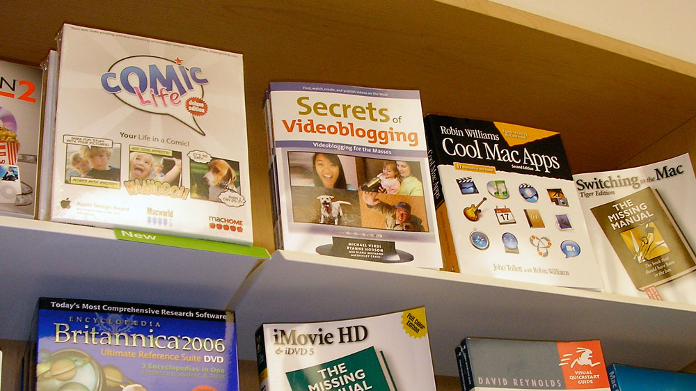 The Secrets of Videoblogging book is displayed on a shelf among other computing books in an Apple store.